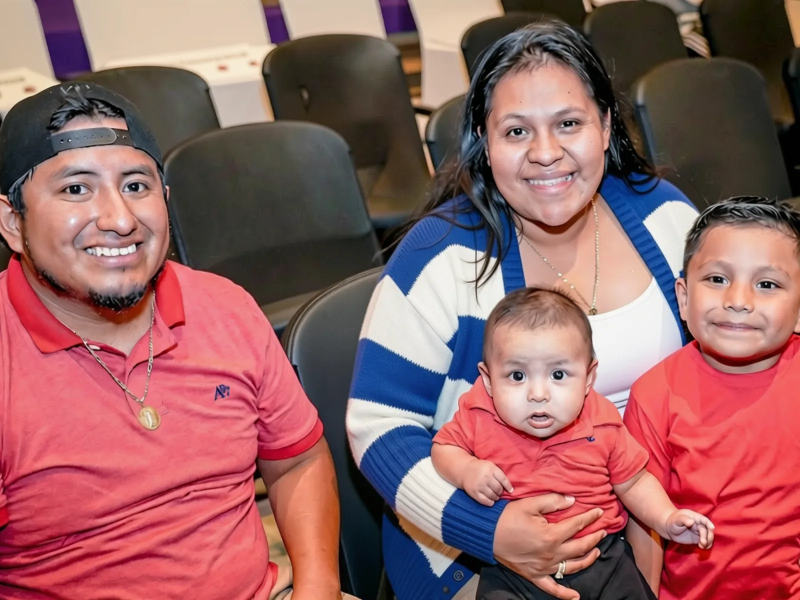 A family smiling together at an EarlystART event