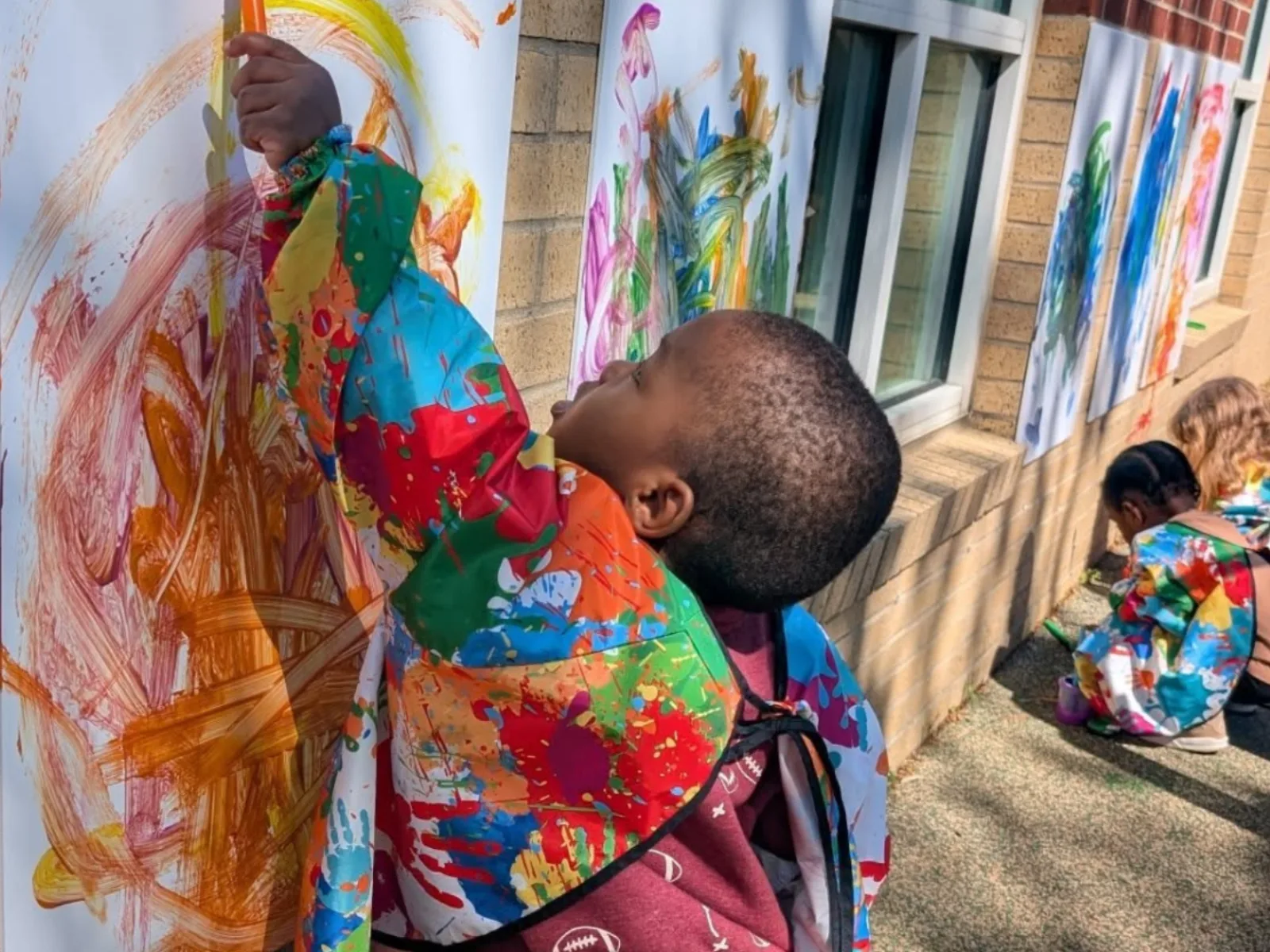 A child painting outdoors